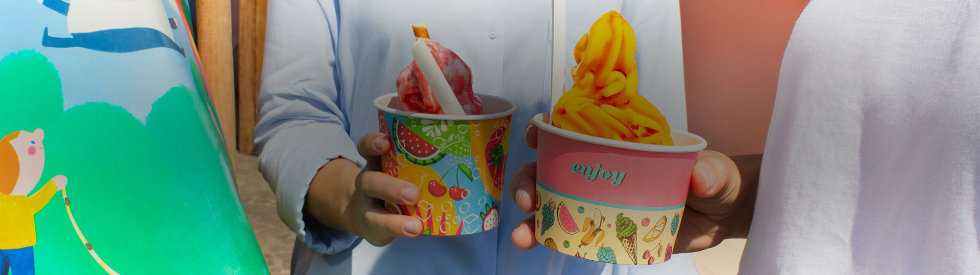 People hold paper cups in their hands.