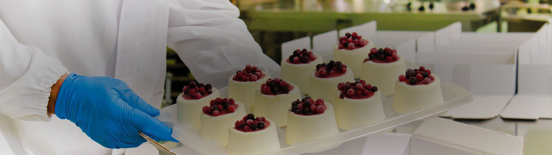 a person in a lab coat holds a tray of sweets